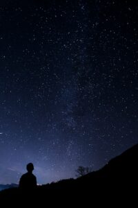 person looking up at nighy sky